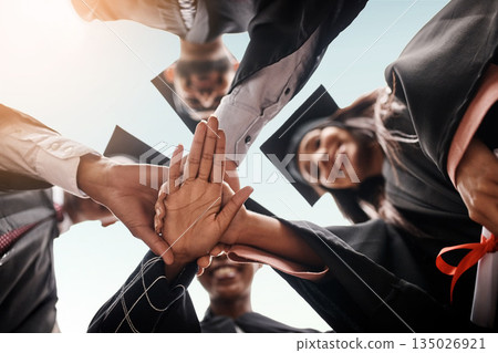Students, graduation and group with hands stacked for college celebration outdoor. Below diversity men and women together for university achievement, education success and school graduate event Students, graduation and group with hands stacked for college celebration outdoor. Below diversity men and women together for university achievement, education success and school graduate event 135026921