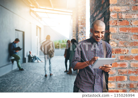 Happy, outdoor and man with a tablet, education and connection for social media, search website for information or network. Male person, guy and student with technology, campus and typing with an app 135026994