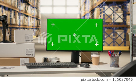 Industrial storage room with mockup chroma key on a computer, space featuring shelves, barcode scanners and packaging materials for order fulfillment. Large scale e-commerce shipment. 135027046