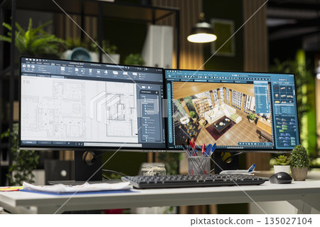 Modern architecture workspace featuring dual monitors with 3D rendering software and floor plan layouts on screen. Interior design, drafting and engineering focused on creativity and innovation. 135027104