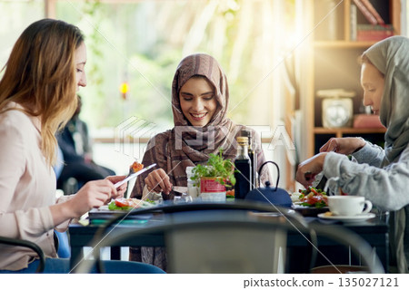 Muslim women, friends and eating in restaurant, together and talking with food, smile or happiness. Islamic woman, group and brunch with conversation, happy face or listening with social chat in cafe Muslim women, friends and eating in restaurant, together and talking with food, smile or happiness. Islamic woman, group and brunch with conversation, happy face or listening with social chat in cafe 135027121