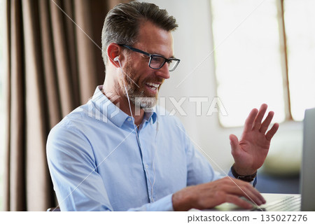 Business man, wave and video call for remote work in home office with smile, happiness or communication. Mature businessman, typing and happy for greeting, webinar and excited with laptop, web or app 135027276