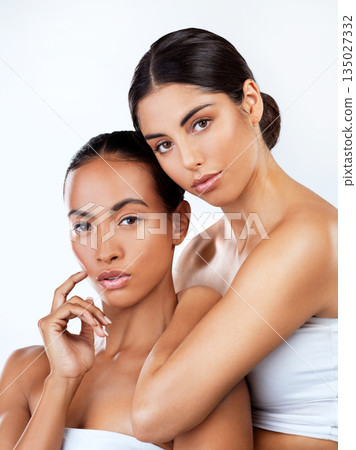 Woman friends, studio portrait and cosmetics for self care, beauty or wellness by white background. Women, skincare and together for support, isolated or diversity with natural glow, face with makeup Woman friends, studio portrait and cosmetics for self care, beauty or wellness by white background. Women, skincare and together for support, isolated or diversity with natural glow, face with makeup 135027332