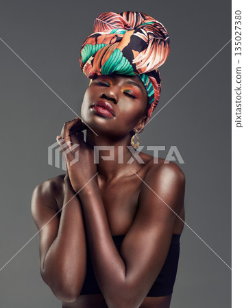 Fashion, beauty and face of black woman in studio on gray background for glamour, cosmetics and makeup. Jewellery, designer and female person in exotic jewelry, African style and head scarf in studio Fashion, beauty and face of black woman in studio on gray background for glamour, cosmetics and makeup. Jewellery, designer and female person in exotic jewelry, African style and head scarf in studio 135027380