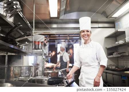 Chef, woman and happy with frying pan in kitchen, catering service and prepare food for fine dining in restaurant. Professional, cooking and female person saute, cook and thinking about hospitality. 135027424
