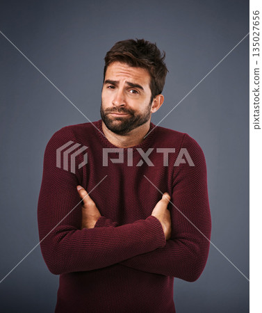 Doubt, shrug and portrait of man in studio unsure against a grey background space. Confused, face and shrugging male with dont know expression, puzzled and pensive with choice and decision isolated 135027656