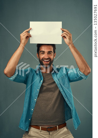 Happy man, portrait and mockup billboard for advertising, marketing or branding against a grey studio background. Male person holding rectangle poster, placard or board for sign or advertisement 135027691