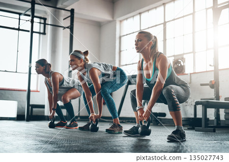 Kettlebell, group and women with fitness, exercise and progress with wellness, balance and workout goal. Female athletes, friends and girls with gym equipment, performance and sports with challenge Kettlebell, group and women with fitness, exercise and progress with wellness, balance and workout goal. Female athletes, friends and girls with gym equipment, performance and sports with challenge 135027743