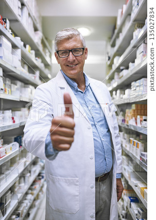 Senior man, doctor and thumbs up at pharmacy for winning, success or approval at clinic store. Portrait of happy elderly male or medical expert showing thumb emoji, yes sign or like in pharmaceutical Senior man, doctor and thumbs up at pharmacy for winning, success or approval at clinic store. Portrait of happy elderly male or medical expert showing thumb emoji, yes sign or like in pharmaceutical 135027834
