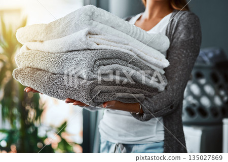 Laundry, hands and woman with towel stack for spring cleaning linen, fabric and textiles to clean in house work. Person, pile of fresh washing or housekeeping, responsibility or domestic housekeeper Laundry, hands and woman with towel stack for spring cleaning linen, fabric and textiles to clean in house work. Person, pile of fresh washing or housekeeping, responsibility or domestic housekeeper 135027869