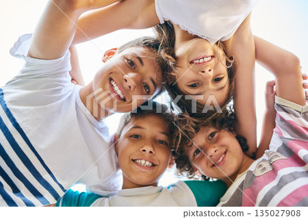 Face, children and family circle or a group of happy siblings together or huddled in solidarity and smiling outdoors. Hug, brothers and sisters or excited kids play or bonding and united outside 135027908