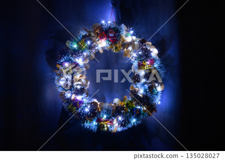 decorative wreath with lighting and toys on a blue background decorative wreath with lighting and toys on a blue background 135028027