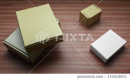 white and craft boxes on a dark wooden table 135028031