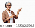 An elderly woman pointing and guiding Copy space 135028598