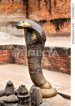 Bronze statues of the mythical Shesh nag guard in a temple pond in Bhaktapur, Kathmandu Bronze statues of the mythical Shesh nag guard in a temple pond in Bhaktapur, Kathmandu 135028627
