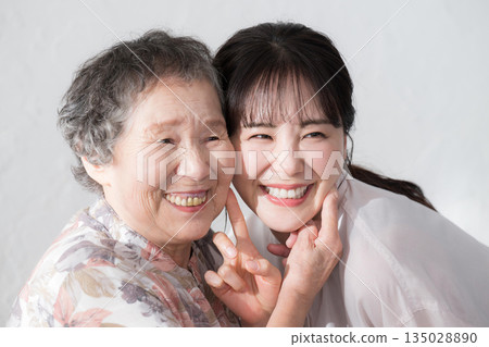 Smiling portrait of grandchild and grandmother Smiling portrait of grandchild and grandmother 135028890