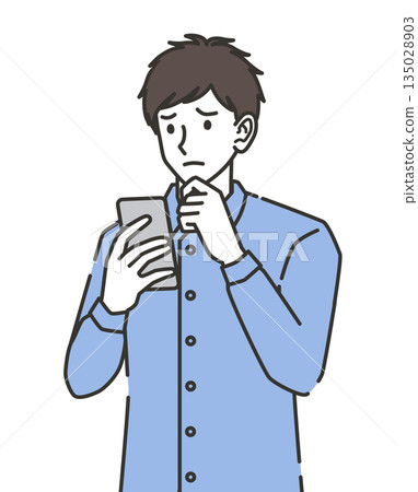 A man in his 20s worried while looking at his smartphone A man in his 20s worried while looking at his smartphone 135028903