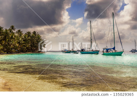 Sailboats at the bay in beautiful unspoiled Caribbean island in San Blas, Panama. Sailboats at the bay in beautiful unspoiled Caribbean island in San Blas, Panama. 135029365