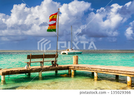 Deck and the Guna people flag on Caribbean San Blas island at politically autonomous Guna territory in Panama. Deck and the Guna people flag on Caribbean San Blas island at politically autonomous Guna territory in Panama. 135029366