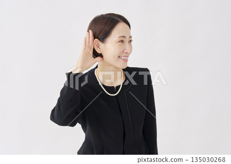 Woman in mourning clothes listening gesture white background Woman in mourning clothes listening gesture white background 135030268