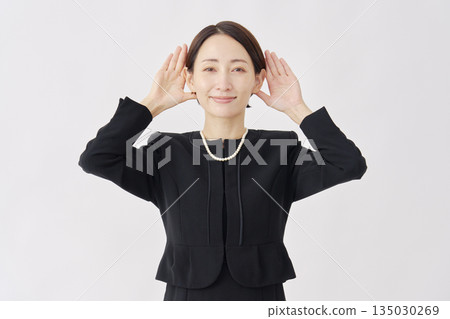 Woman in mourning clothes listening gesture white background 135030269