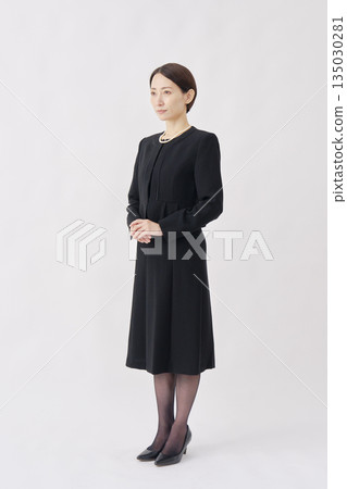 Portrait of a woman in mourning clothes, white background, full body, facing left 135030281