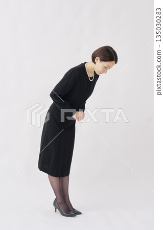 Woman in mourning clothes bowing white background full body right facing Woman in mourning clothes bowing white background full body right facing 135030283