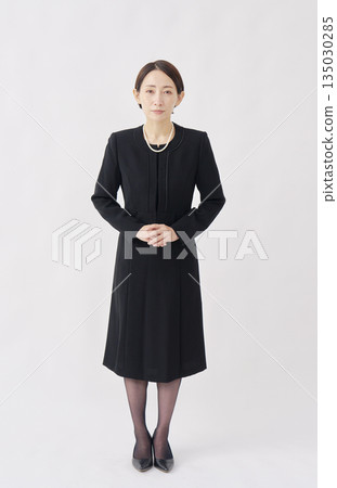Woman in mourning clothes bowing white background whole body looking at camera Woman in mourning clothes bowing white background whole body looking at camera 135030285