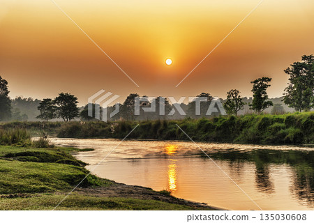 Sunset over the river in Chitwan National Park, Nepal Sunset over the river in Chitwan National Park, Nepal 135030608