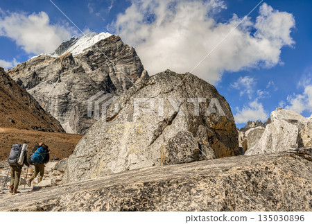 Trekkers on the trail to Dingboche on the way to Everest Base Camp, Nepal. 135030896