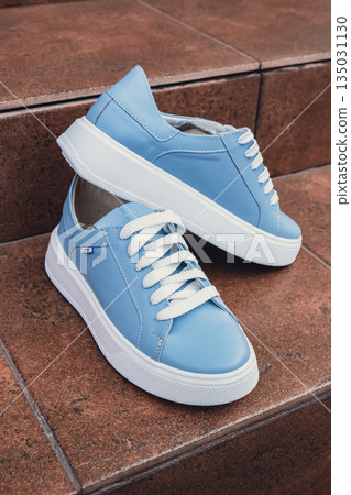 Elegant blue leather womens shoes blank product for branding displayed. New casual female sneakers no-brand footwear e-commerce. No logo product unbranded fashion 135031130