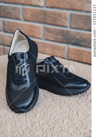 Elegant black leather womens shoes blank product for branding displayed. New casual female sneakers no-brand footwear e-commerce. No logo product Elegant black leather womens shoes blank product for branding displayed. New casual female sneakers no-brand footwear e-commerce. No logo product 135031133