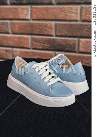 Elegant blue leather womens shoes blank product for branding displayed. New casual female sneakers no-brand footwear e-commerce. No logo product unbranded fashion 135031158