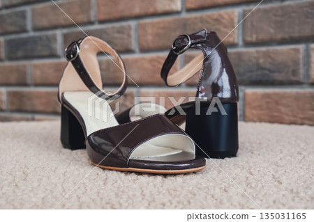 Elegant patent leather sandals high heels blank product for branding displayed. New casual female sandals no-brand footwear e-commerce. No logo product unbranded fashion footwear 135031165
