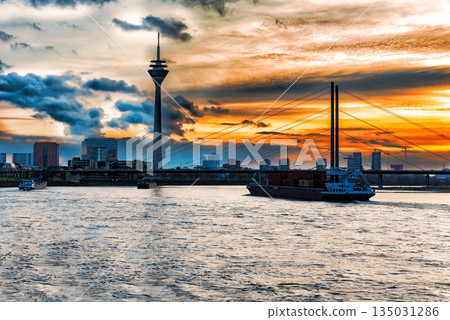 Sunset over the Rhine river with bridge and Dusseldorf city scape, Germany 135031286