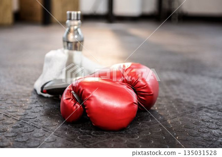 Boxing gloves with bottle on floor Boxing gloves with bottle on floor 135031528