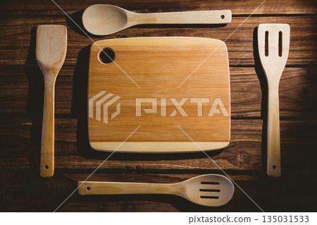 Wooden chopping board with utensils Wooden chopping board with utensils 135031533