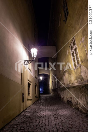 Flat design showing cobblestone alley glowing by lanterns and arches framing windows forming tunnel Flat design showing cobblestone alley glowing by lanterns and arches framing windows forming tunnel 135031574