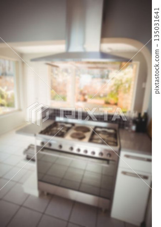 Flat kitchen design showing gas range with oven under hood, black backsplash, garden-viewing window 135031641
