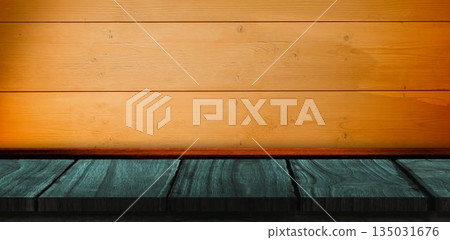 Green wooden shelf on orange wall 135031676