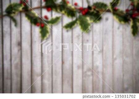 Flat design holly garland with red berries is draping across wooden planks backdrop, copy space Flat design holly garland with red berries is draping across wooden planks backdrop, copy space 135031702