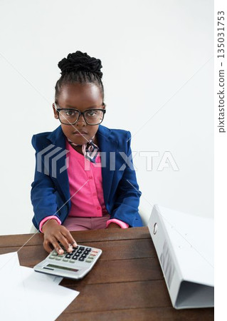 Portrait of businesswoman using calculator 135031753