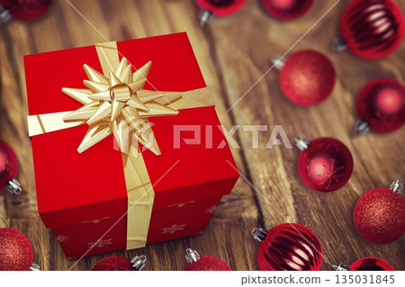 Flat design red gift box with gold ribbon bow is sitting on wood table with baubles Flat design red gift box with gold ribbon bow is sitting on wood table with baubles 135031845