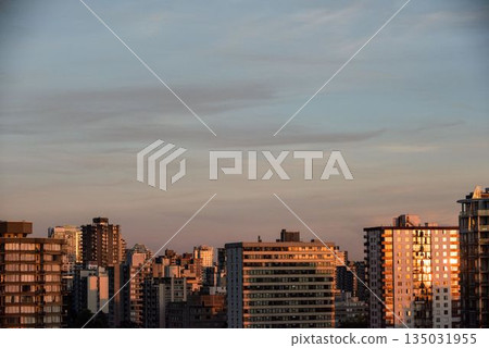 Sunlight falling on buildings during sunset Sunlight falling on buildings during sunset 135031955