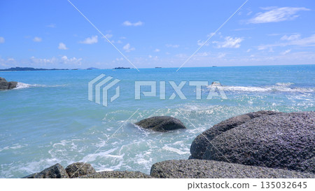 Calm Turquoise Sea Water and Granite Boulders Under Blue Sky Sungailiat Calm Turquoise Sea Water and Granite Boulders Under Blue Sky Sungailiat 135032645
