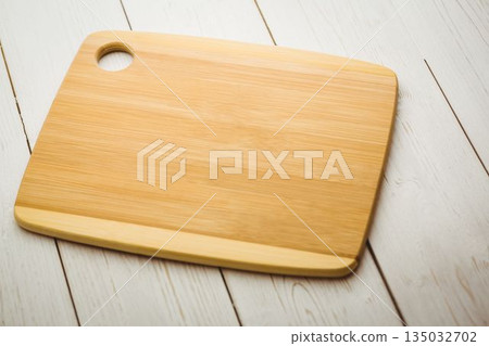 Chopping board on white wooden flooring 135032702