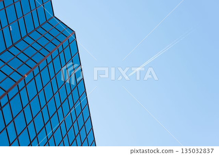 Low angle view of office building against blue sky Low angle view of office building against blue sky 135032837