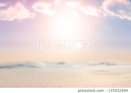 Glowing sun is casting warm pastel light over calm water or dunes in flat design 135032894