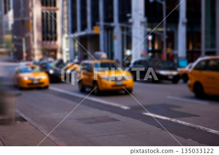 Yellow taxi SUV is driving past traffic lights on blurred downtown avenue in flat design style 135033122