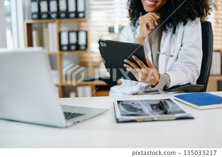 Medical technology concept. Doctor working with mobile phone and stethoscope and digital tablet laptop 135033217